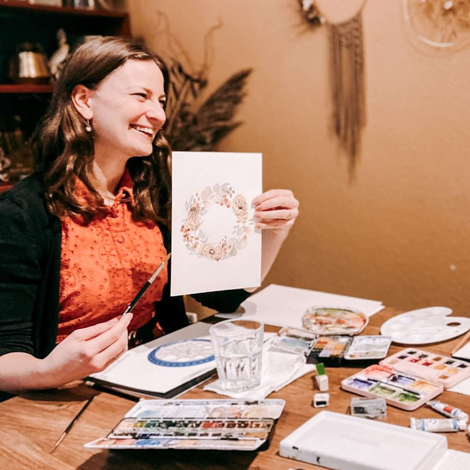 Frau hält Aquarell-Blumenzeichnung hoch, kreativer Workshop für Kunst und DIY bei Grimms Garten Berlin