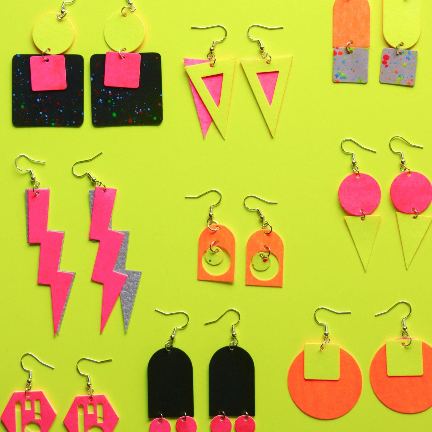 Gelber Hintergrund mit Ohrringen aus veganem Leder in verschiedenen Formen und Farben – Schmuckdesign Kurs.