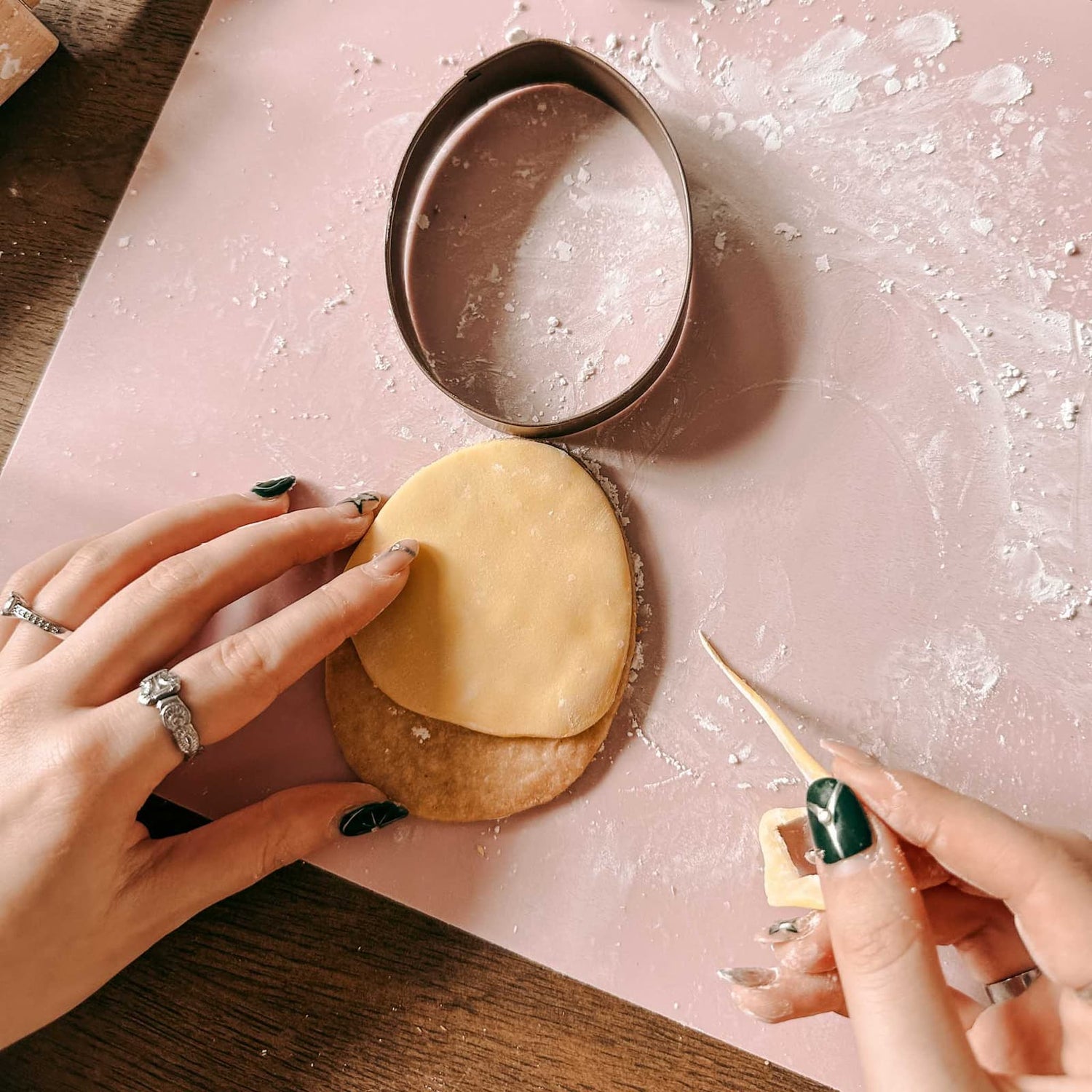 Hände formen Fondant auf einem Keks mit Ei-Ausstechform beim Osterkekse Workshop von GRIMMS GARTEN, kreativer Backkurs in Berlin
