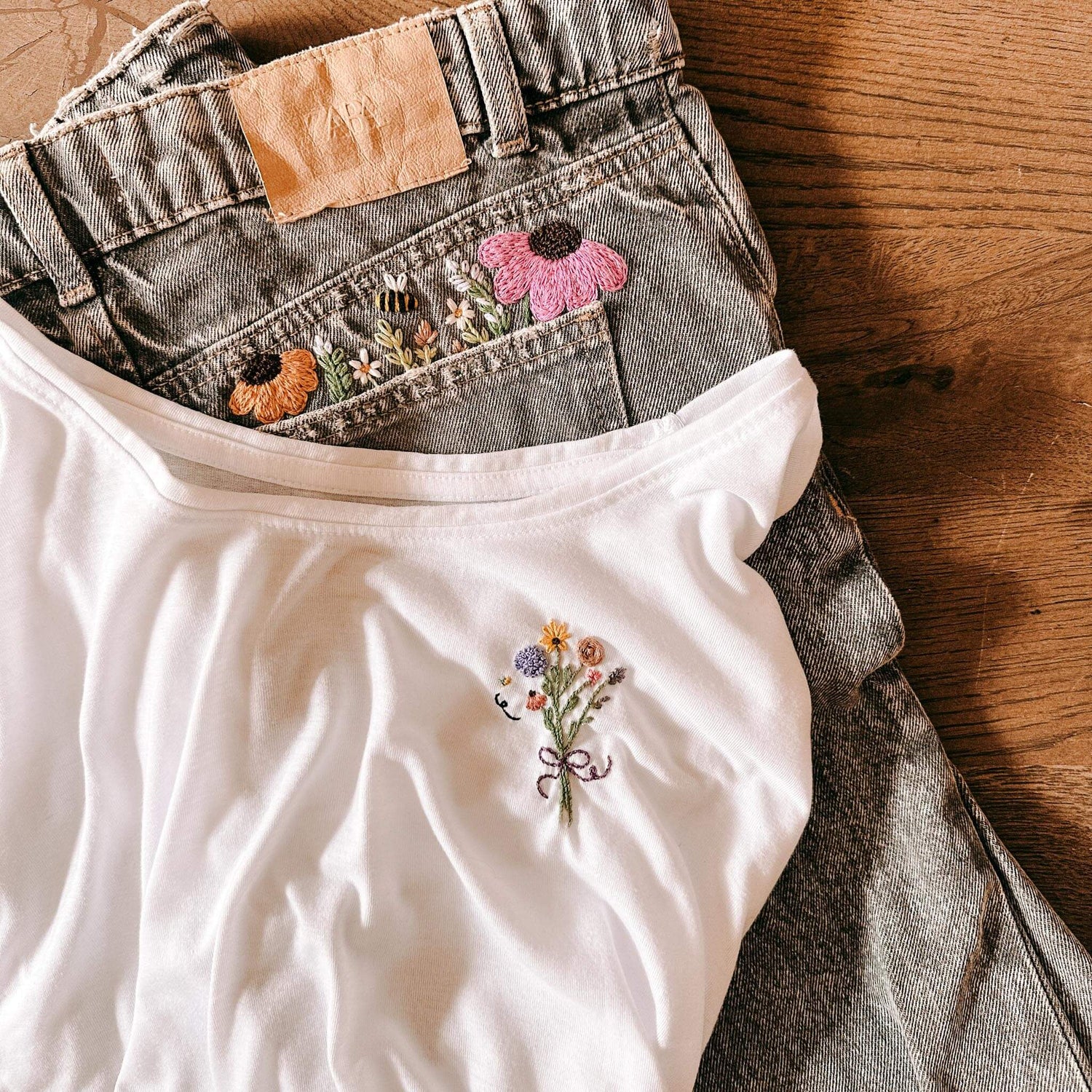Weißes Top und graue Jeans mit gestickten Blumen – kleidung besticken, upcycling fashion, nachhaltige mode, diy stickerei.