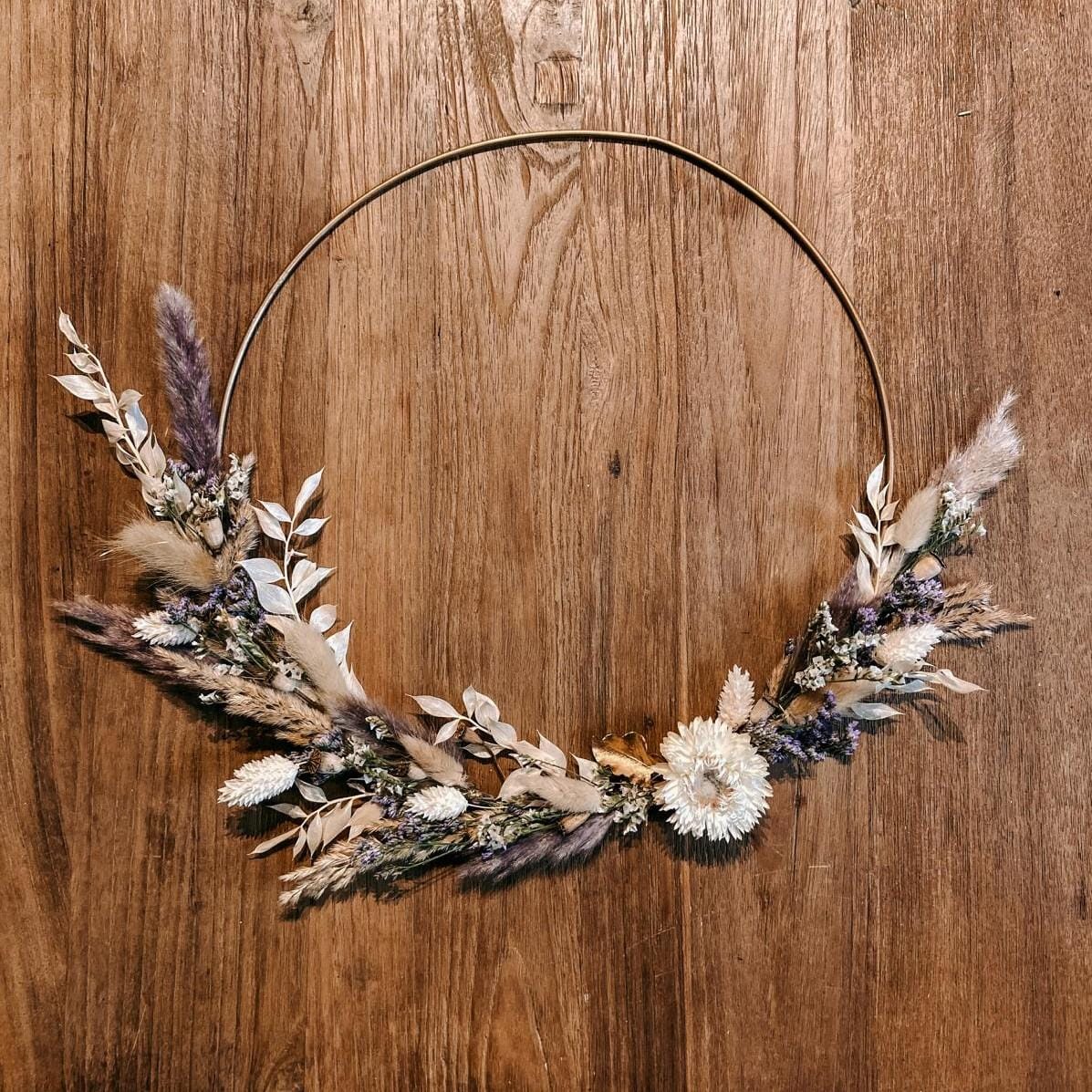 Fertiger lila-weißer Trockenblumenring auf Holztisch – Boho-Chic Workshop, DIY, Firmenevent.