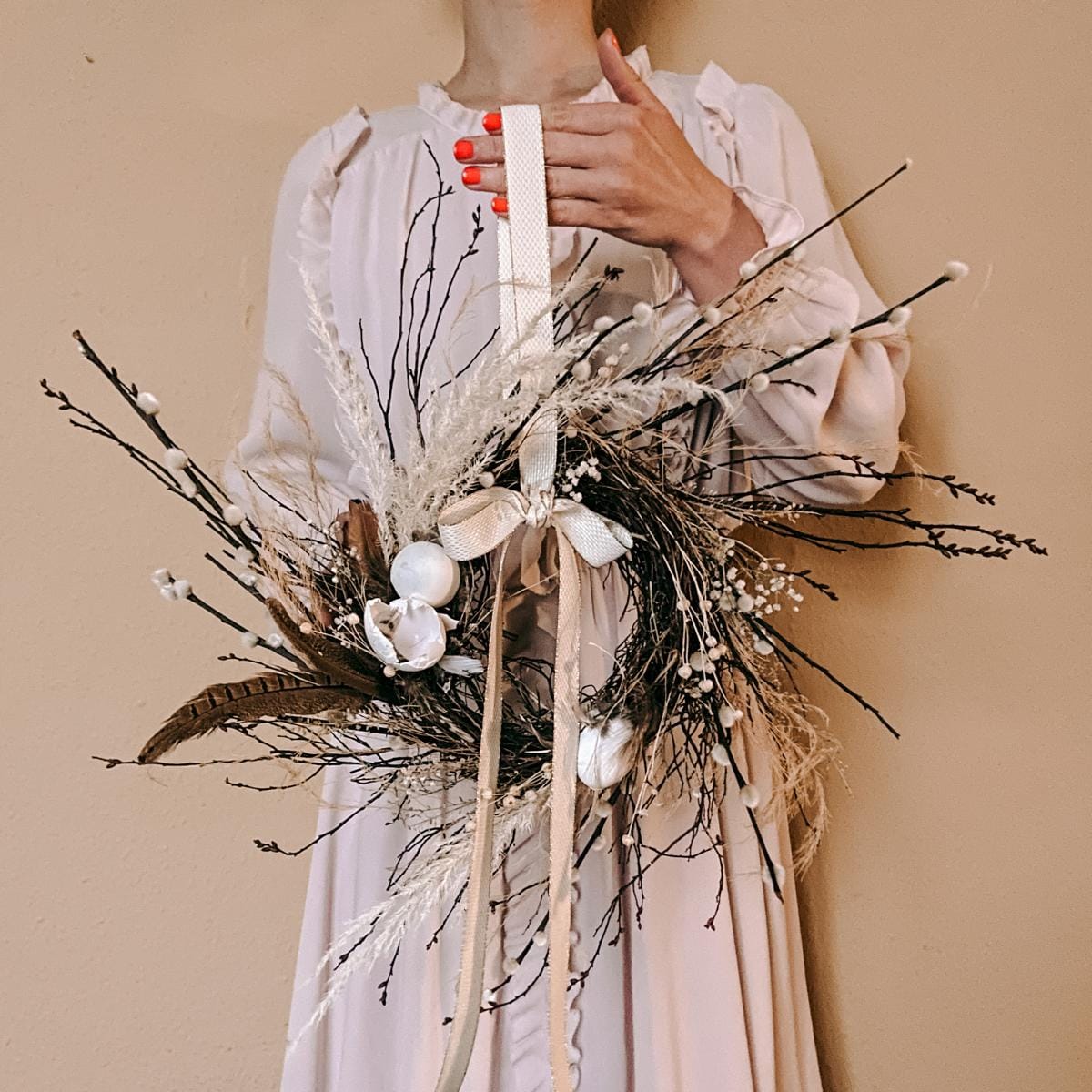 Person hält Osterkranz in die Höhe – DIY Osterkranz Workshop für JGA oder Teamevent.