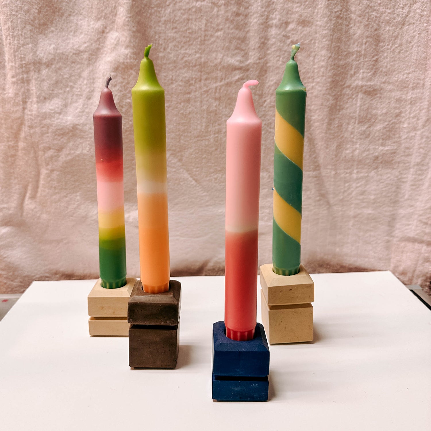 Bunte dip dye kerzen im Holzständer auf Tisch – kerzen workshop berlin, kerzen färben.Auch als Firmenevent buchbar.