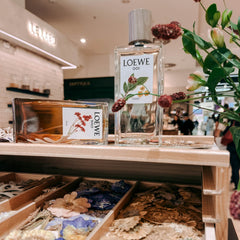 Zwei Parfum Flakons auf Holzständern mit Trockenblumen dekoriert im Kreativ Workshop von GRIMMS GARTEN Berlin